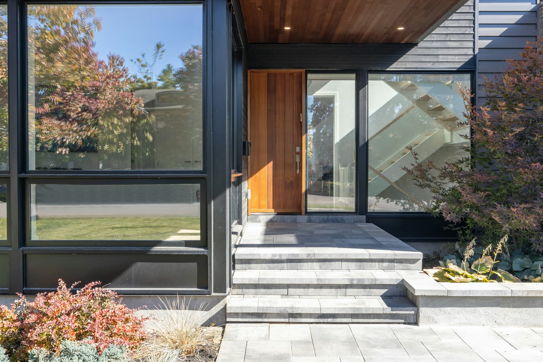 Window and entry-door design inspiration with dark frames and warm wood finishes